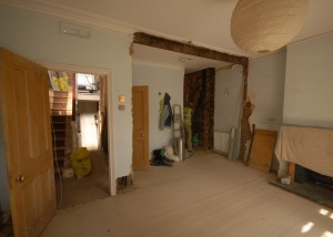 The living room where the arch and the chimney breast have been removed