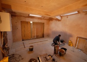 The floor tiles being laid - plastering has been done